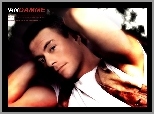 Jean Claude Van Damme,biała koszulka, kamizelka